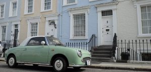 A block of houses in Notting Hill with a retro lime green car outside. Asian tantric masseuses are available in this district for professional massages everyday of the week