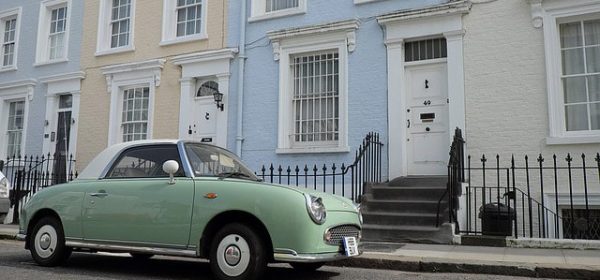 A block of houses in Notting Hill with a retro lime green car outside. Asian tantric masseuses are available in this district for professional massages everyday of the week