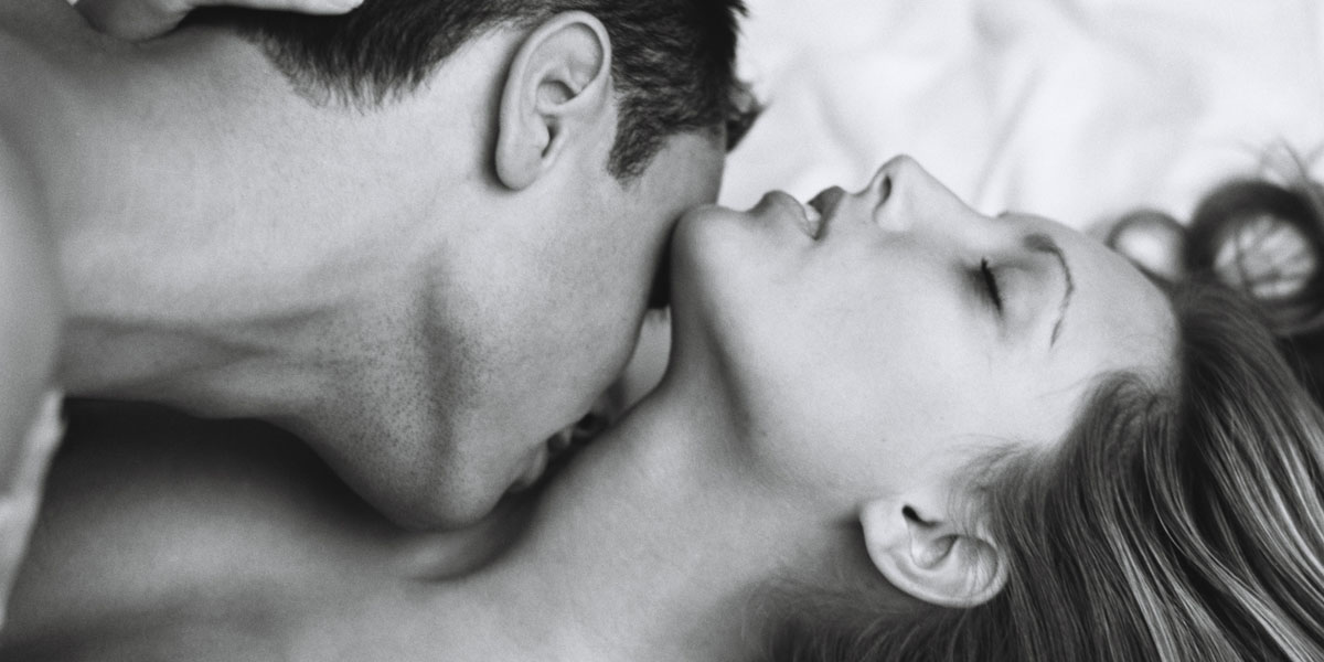 A man kissing a woman's neck during a B2B massage