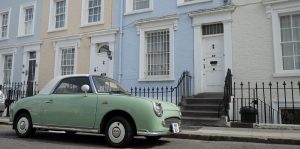 A lime green car outside of some London homes