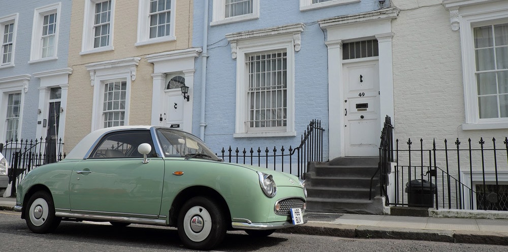 A lime green car outside of some London homes