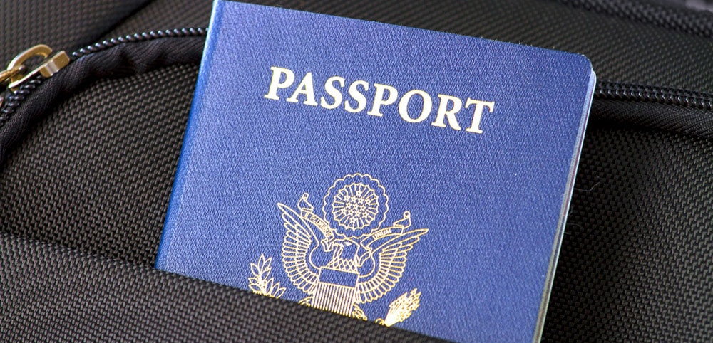 A passport inside of a black bag